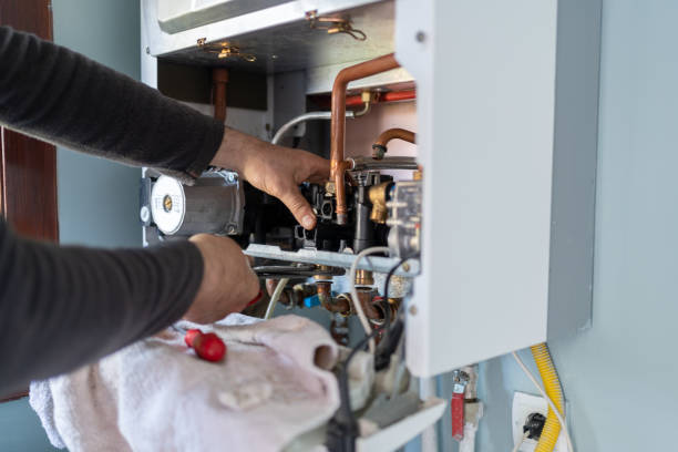 technician repairing natural gas combi boiler at home technician repairing natural gas combi boiler at home